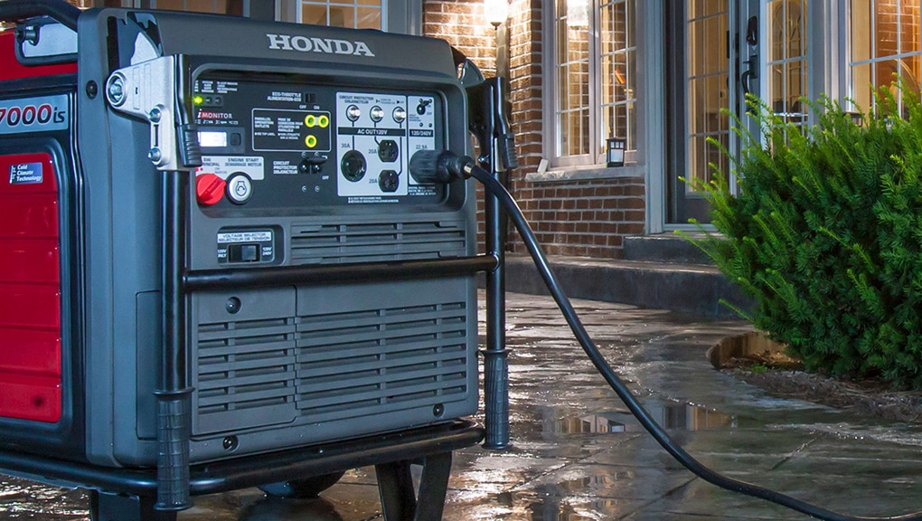 Close up night time image of generator poolside in backyard of house with lights on